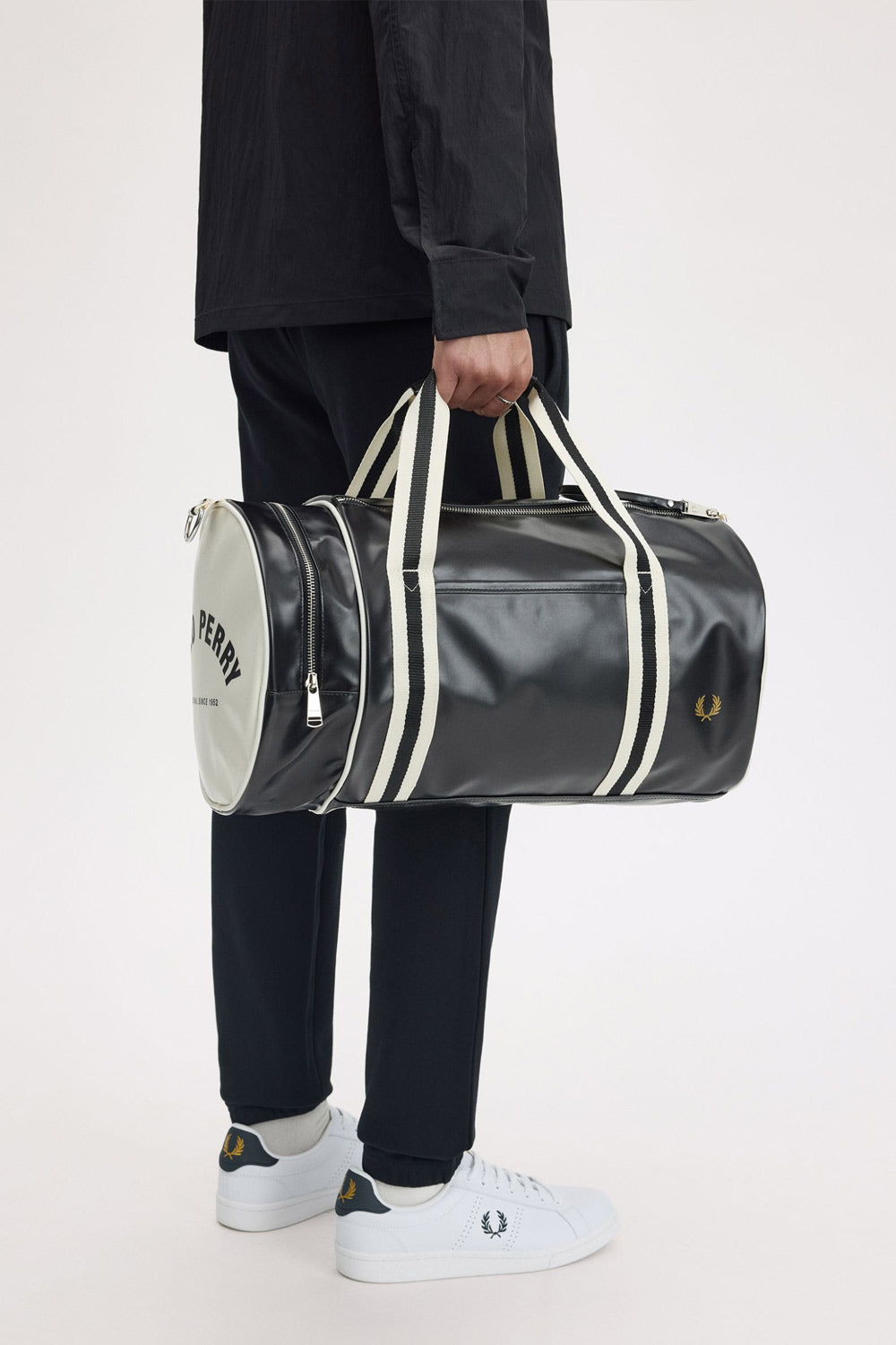 man holding the fred perry Classic Barrel Bag Black Ecru