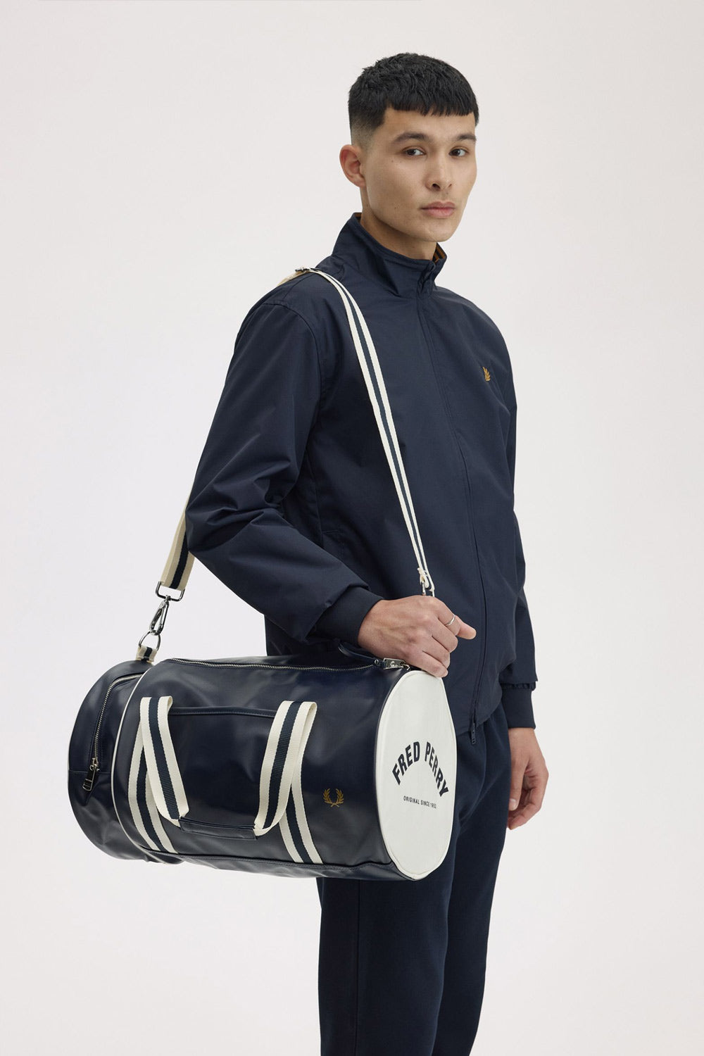 Man with Fred perry barrel bag on his shoulder