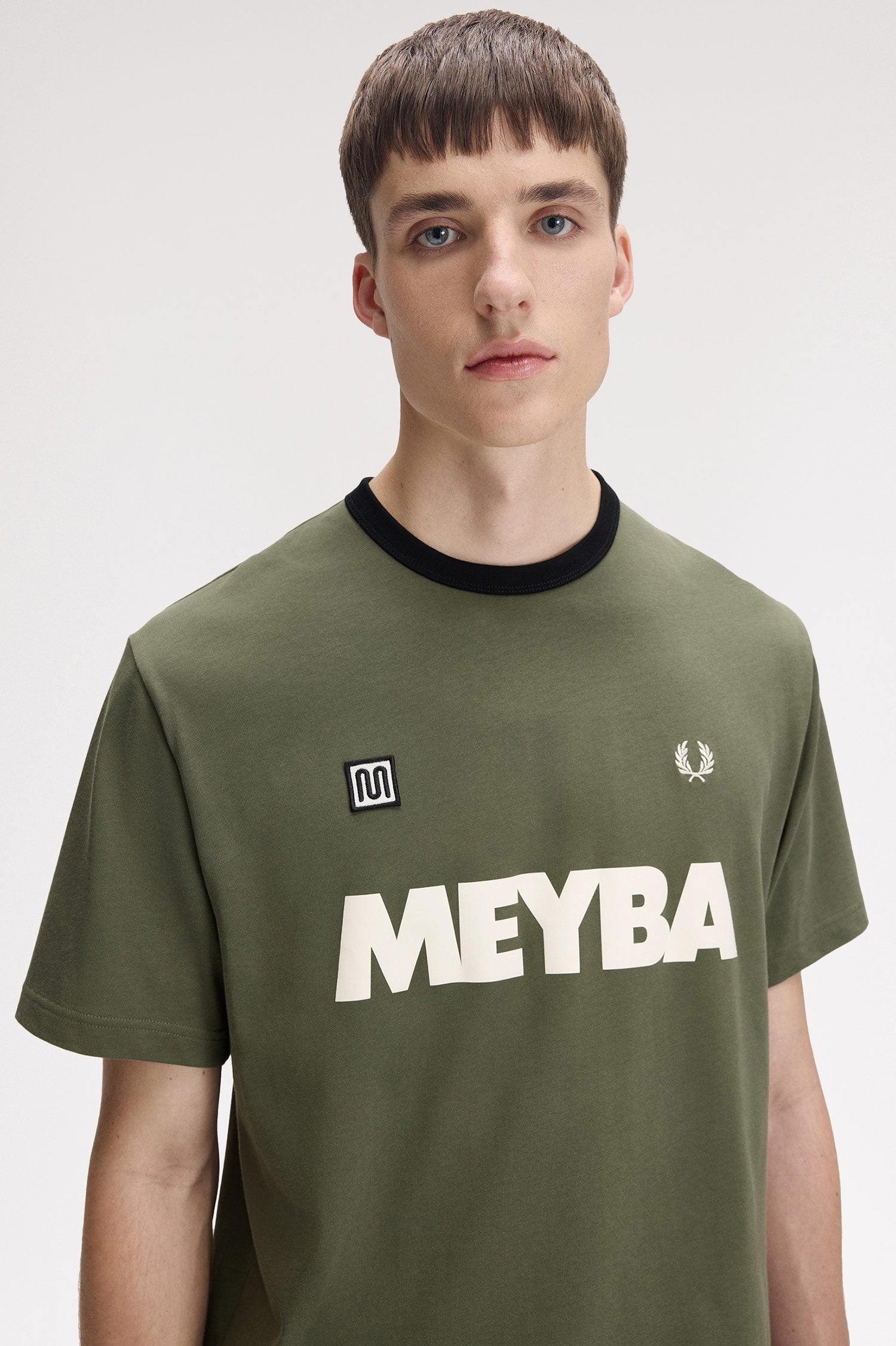 Model wearing Fred Perry x Meyba Ringer T-Shirt in Green