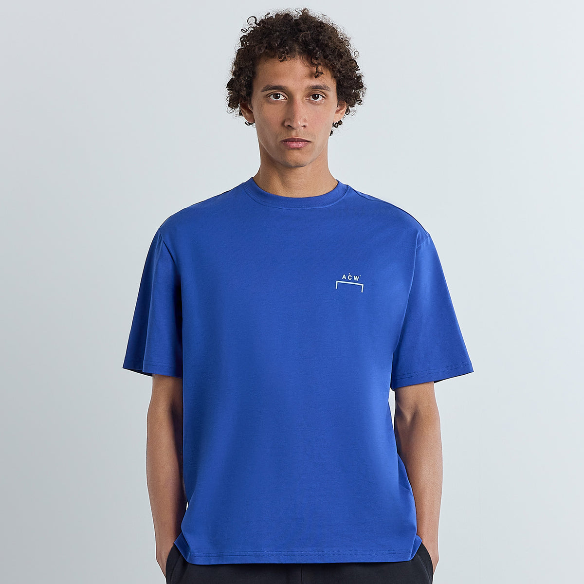 A man wearing a cold wall Chrome T Shirt Bluist