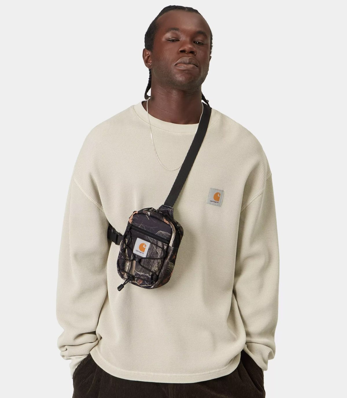 Man wearing a Carhartt WIP Kickflip Shoulder Bag Camo Feather Tree