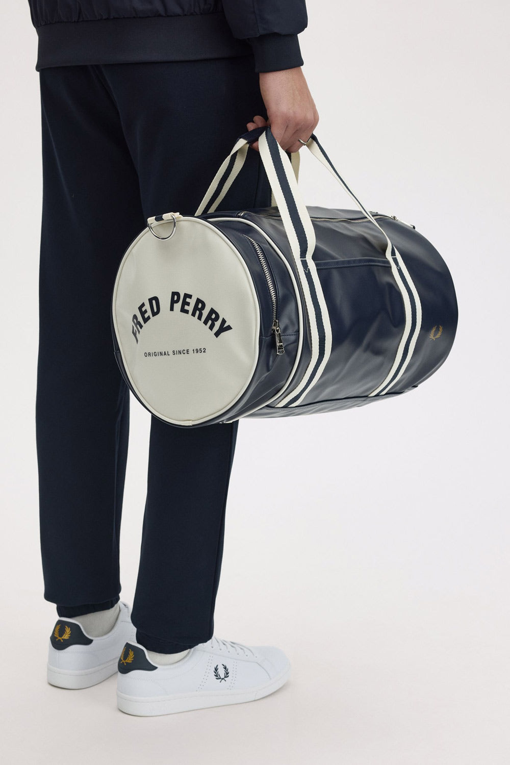 Man holding Fred Perry Barrel bag in his hand