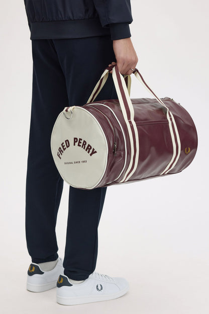 man holding a fred perry Classic Barrel Bag Oxblood Ecru