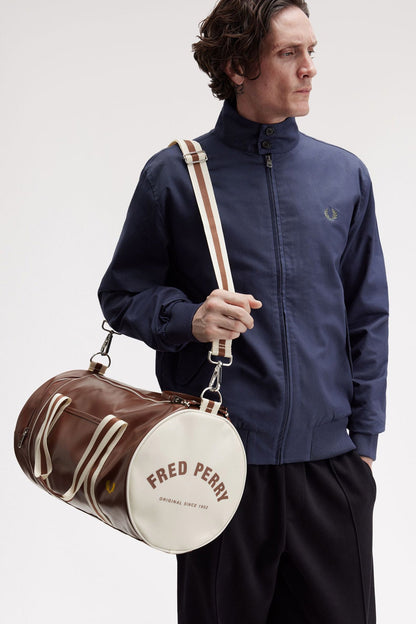 a man wearing a fred perry Classic Barrel Bag Tan Ecru over his shoulder