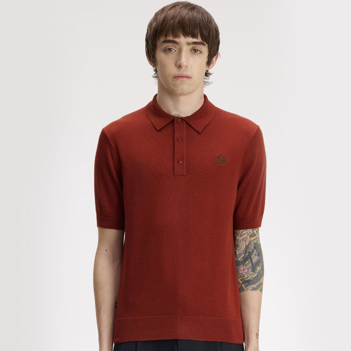 a man wearing fred perry Short Sleeve Cotton Knitted Polo Shirt Brandy