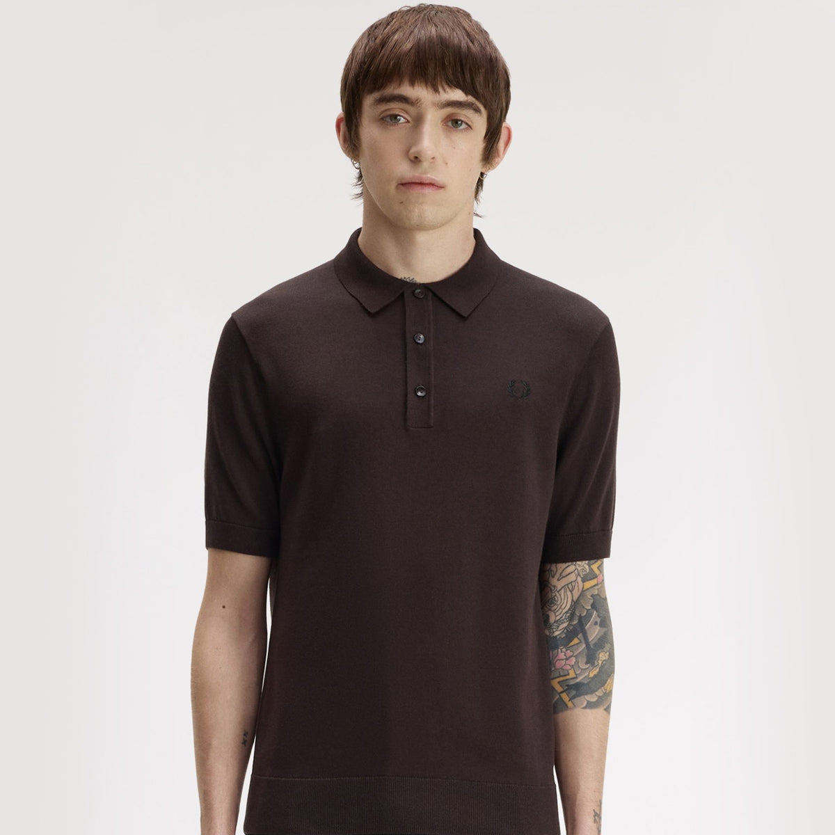 A man wearing fred perry Short Sleeve Cotton Knitted Polo Shirt Rich Brown