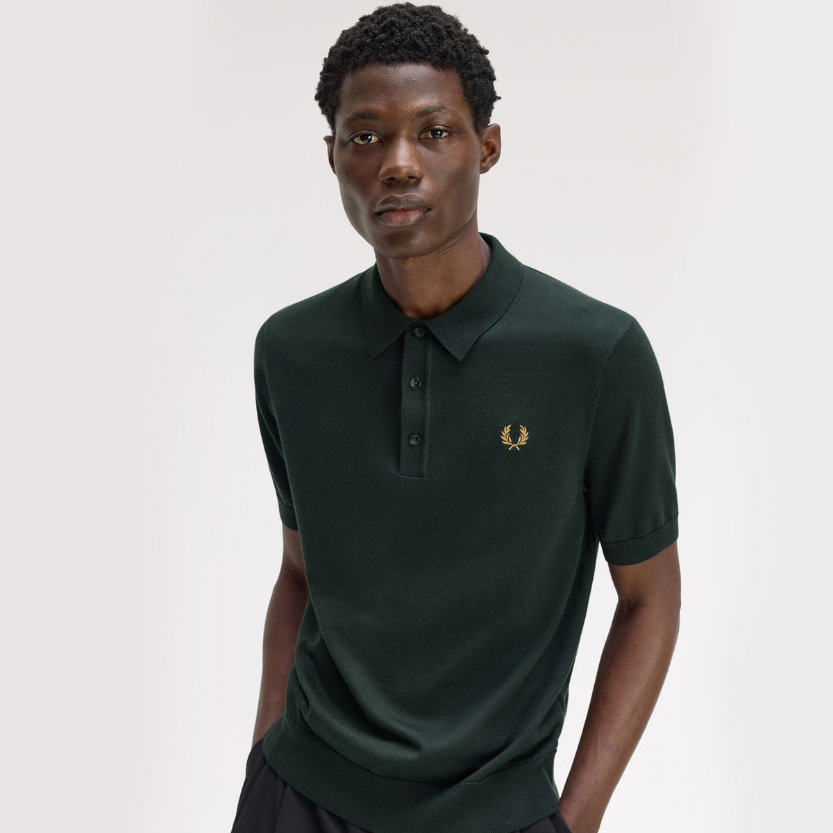 A model wearing fred perry Short Sleeve Knitted Cotton T Shirt Night Green