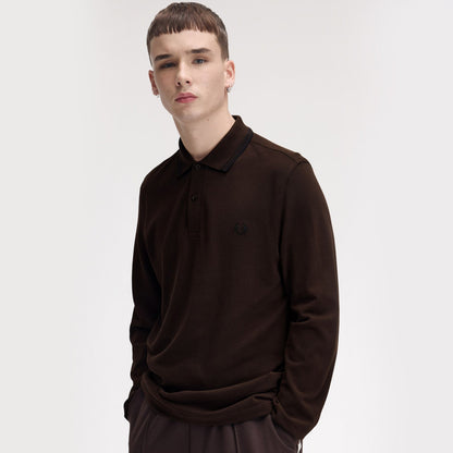 A man wearing fred perry Long Sleeve Twin Tipped Polo Shirt Rich Brown / Black
