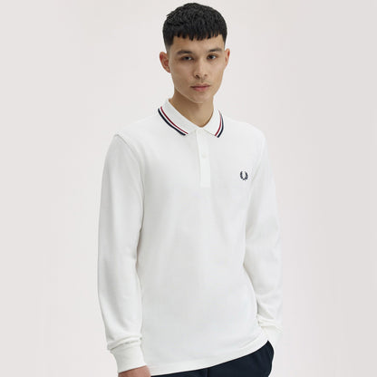 A man wearing fred perry Long Sleeve Twin Tipped Polo Shirt Snow White / Burnt Red / Navy