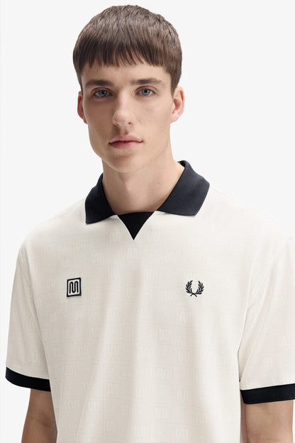 Model wearing Fred Perry x Meyba Printed Polo in Ecru