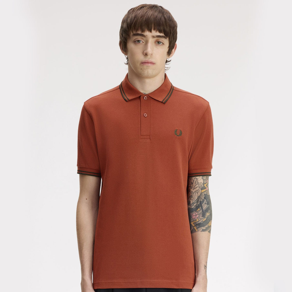 a model wearing fred perry Short Sleeve Twin Tipped Polo Shirt Twilight Brandy / Night Green