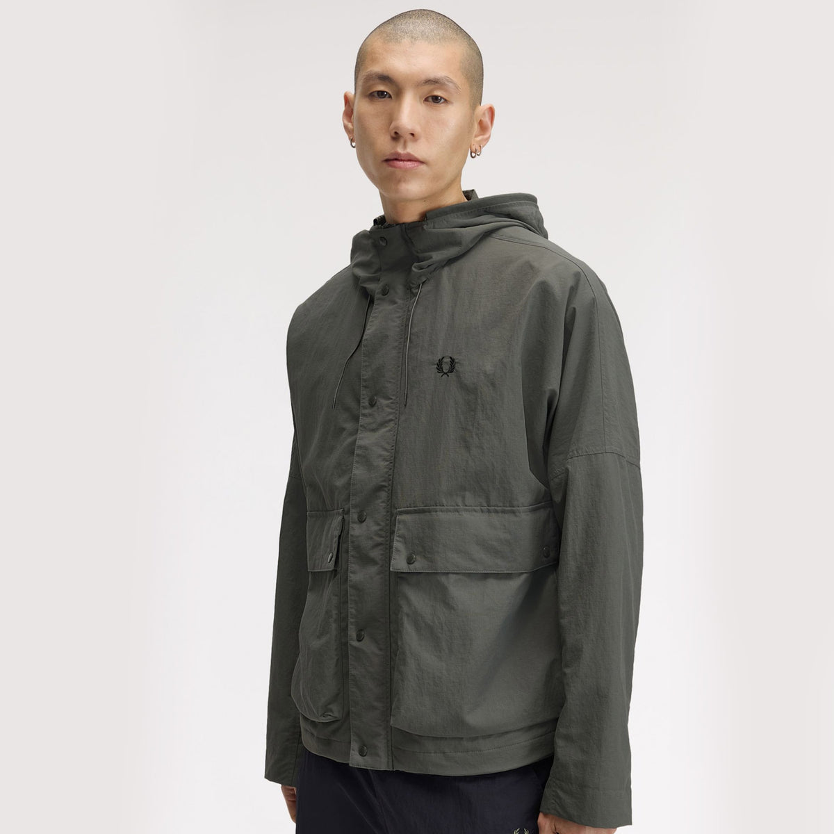 A model wearing Fred Perry Cropped Ripstop Parka Field Green