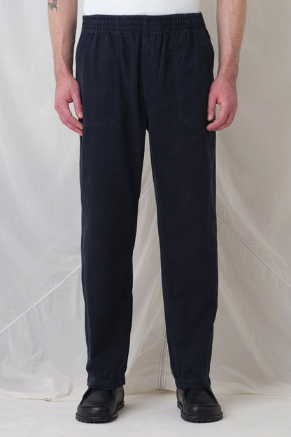Man wearing Pexwear C Trousers - chef trousers - in navy